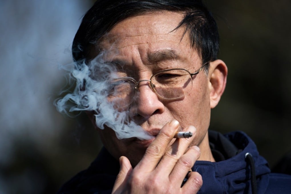A man smokes a cigarette in Shanghai, one of the Chinese cities to have a smoking ban. Smoking-related illnesses kill more than a million people a year in China. Photo: AFP