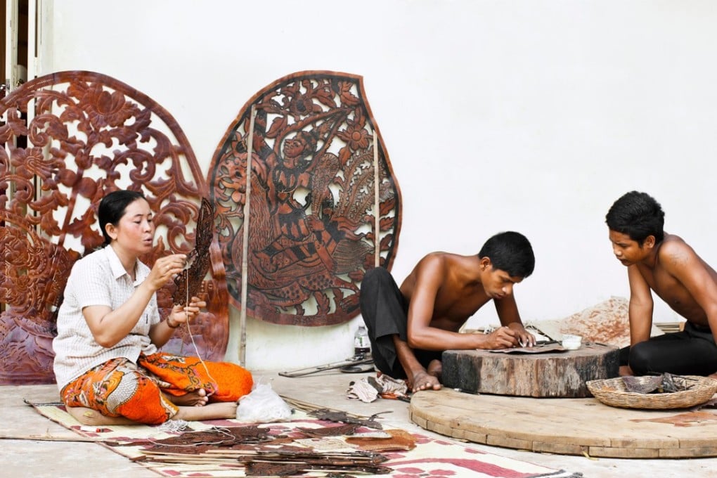 Artists from Cambodia Living Arts make shadow puppets at their home in Siem Reap, Cambodia. Photo: Alamy