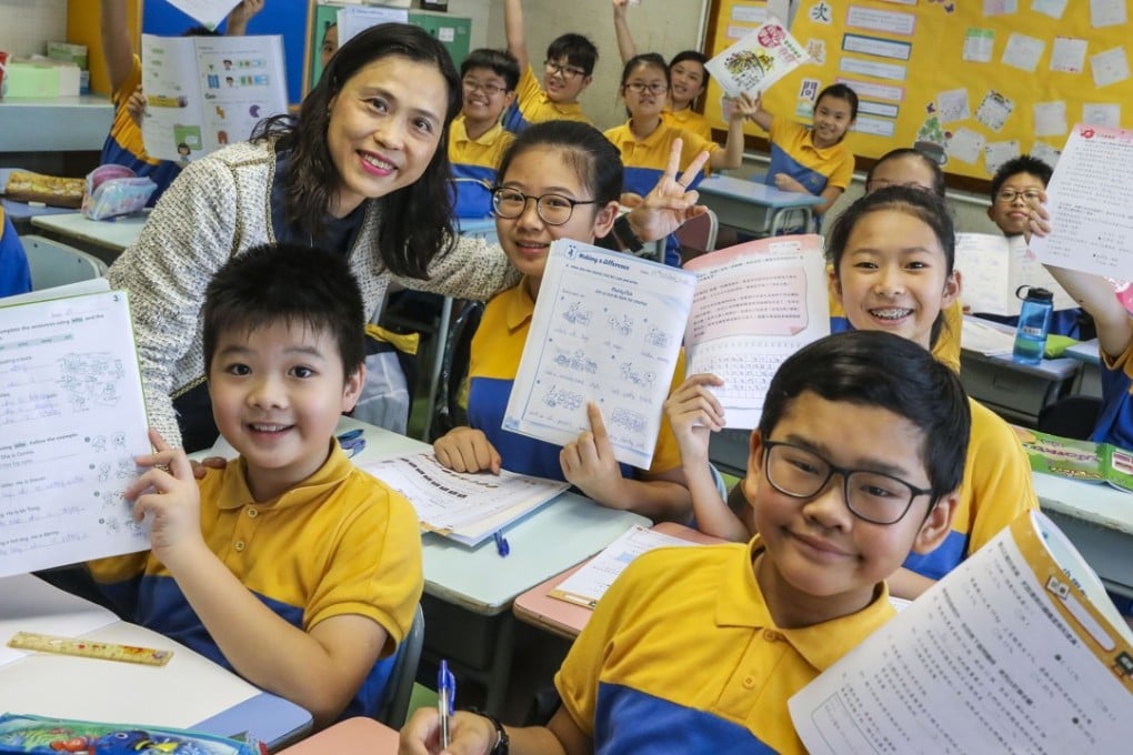 Principal Jojo Chan, with some of her pupils, says most parents approve of the arrangement. Photo: K.Y. Cheng