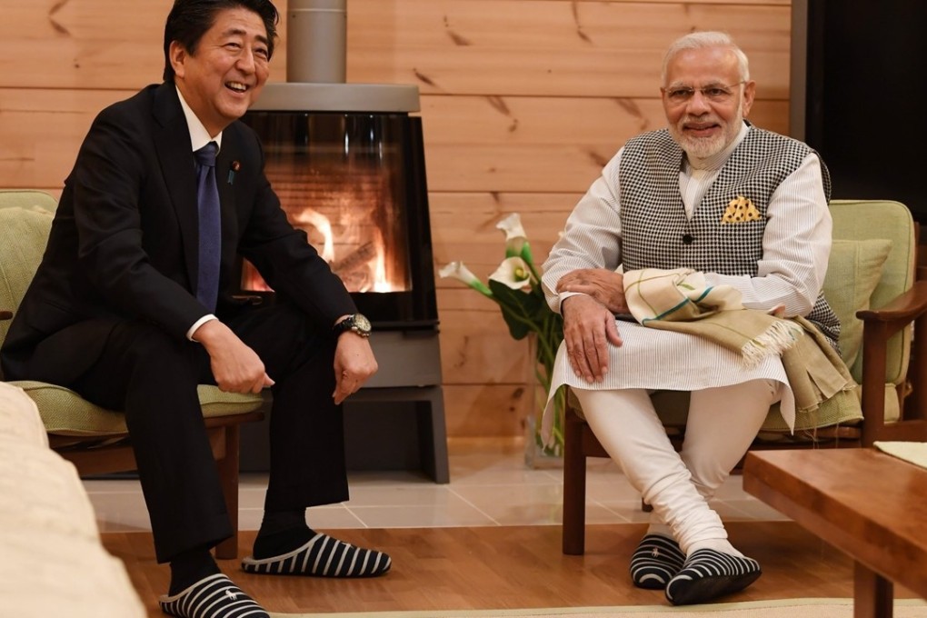 Japanese leader Shinzo Abe and Indian counterpart Narendra Modi wear slippers by the fire at Abe's holiday home. Photo: Twitter