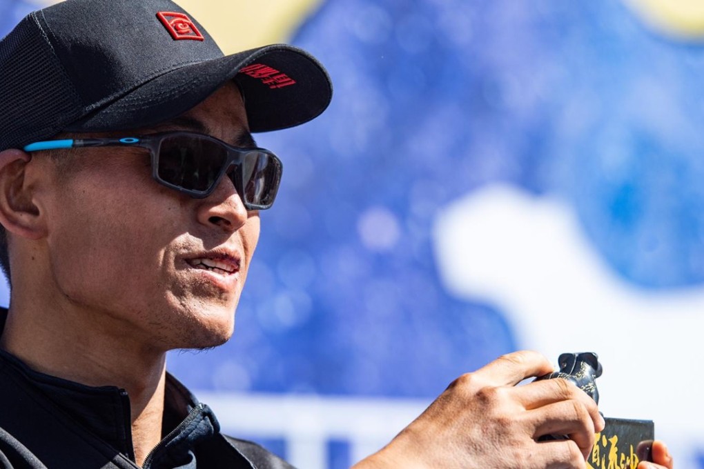 Liang Jing receives his winner’s medal for the Ultra Gobi – the Chinese runner is working on a ‘new me’ following his HK100 disqualification. Photo: Ocean Visuals