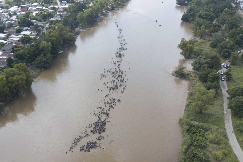 A new group of Central American migrants bound for the US border wade in mass across the Suchiate River, that connects Guatemala and Mexico. Photo: AP