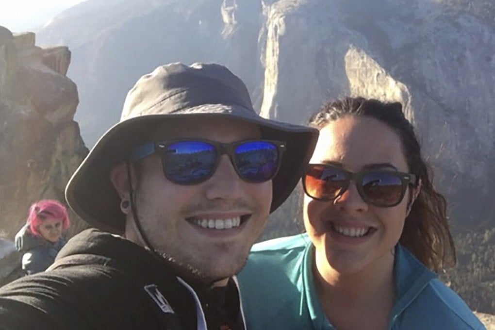 In this October 21, 2018 photo provided by Sean Matteson, Matteson poses for a selfie with his girlfriend Drea Rose Laguillo, at Taft Point in Yosemite National Park, California. Over Matteson’s shoulder is Meenakshi Moorthy, who later fell to her death from the popular overlook. Photo: Sean Matteson via AP