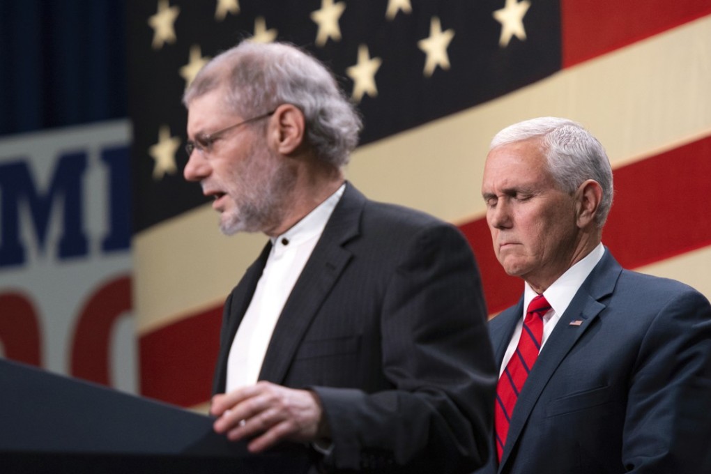 Vice-President Mike Pence, right, prays with Loren Jacobs for the victims and families of those killed in the Pittsburgh synagogue shooting, at a rally for Republicans in Oakland County, Michigan, on Monday. At the rally Loren Jacobs, who uses the title “rabbi” but espouses Christianity, was invited to speak on behalf of the area's Jewish community. Photo: AP