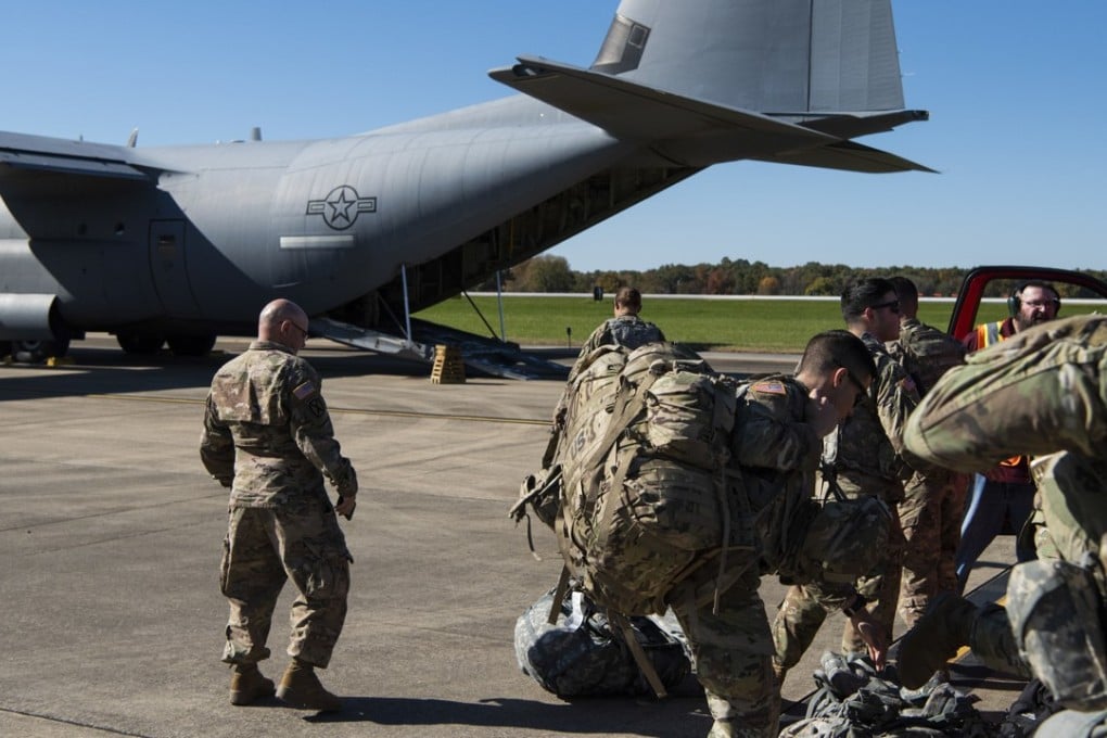 Troops get ready to board a C-130J Super Hercules on Monday in support of Operation Faithful Patriot. Photo: AP