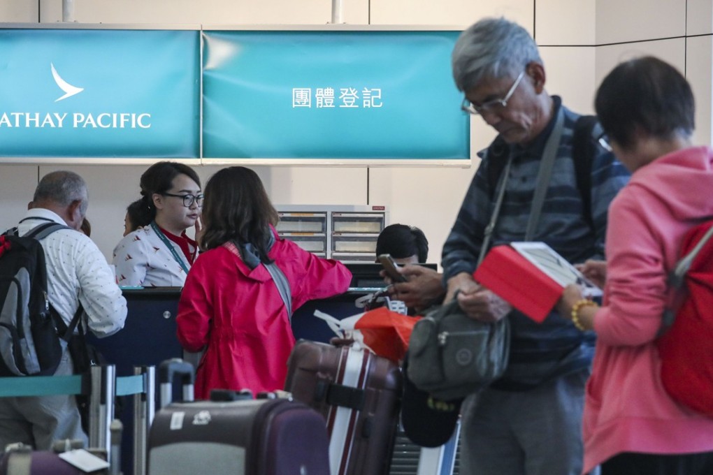 Passengers line up at Cathay Pacific check-in aisles at Hong Kong International Airport on October 29. The airline has announced a data breach affecting 9.4 million customers. Photo: Felix Wong