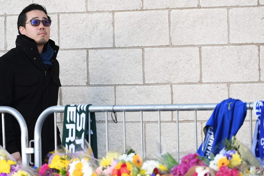 Aiyawatt Srivaddhanaprabha, the son of Leicester City chairman Vichai Srivaddhanaprabha, who died in a helicopter crash at the club’s stadium, looks at the floral tributes left to the victims of the crash. Photo: AFP