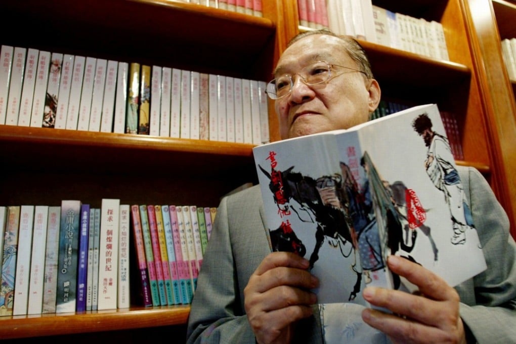 Novelist Louis Cha holding a copy of ‘Book and Sword, Gratitude and Revenge’ at his office in 2002. Photo: Reuters