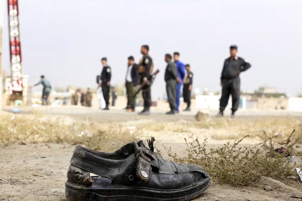 Afghan security officials inspect the scene of a suicide bomb attack in Kabul. Photo: EPA