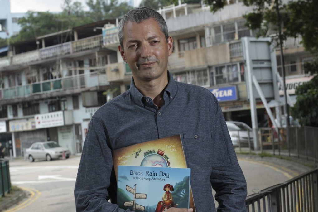 Writer Matthew Cooper with his book Black Rain Day - A Hong Kong Adventure. Picture: Dickson Lee