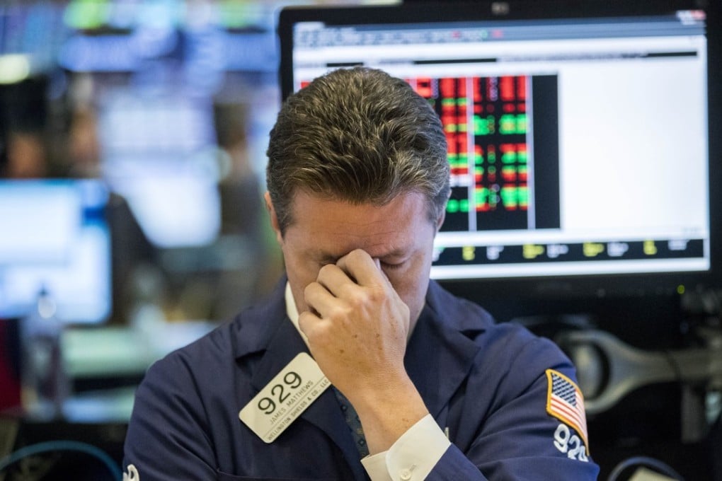 A trader reacts at the New York Stock Exchange on October 11 when US stocks extended deep losses in volatile trading. Photo: Xinhua