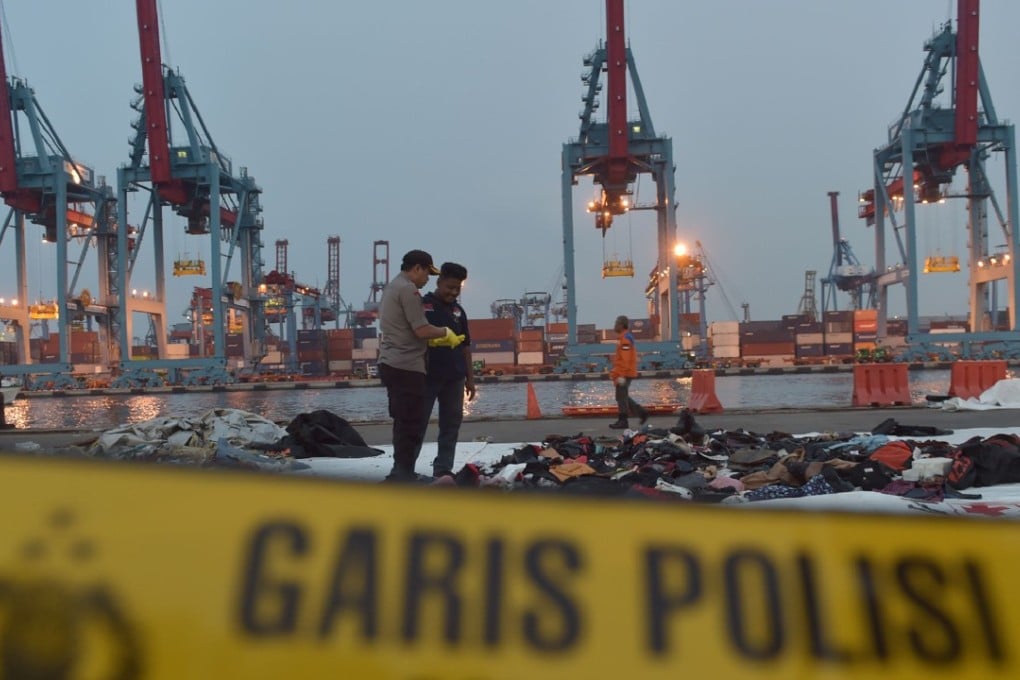 Indonesian policemen examining debris of the ill-fated Lion Air flight. Photo: AFP