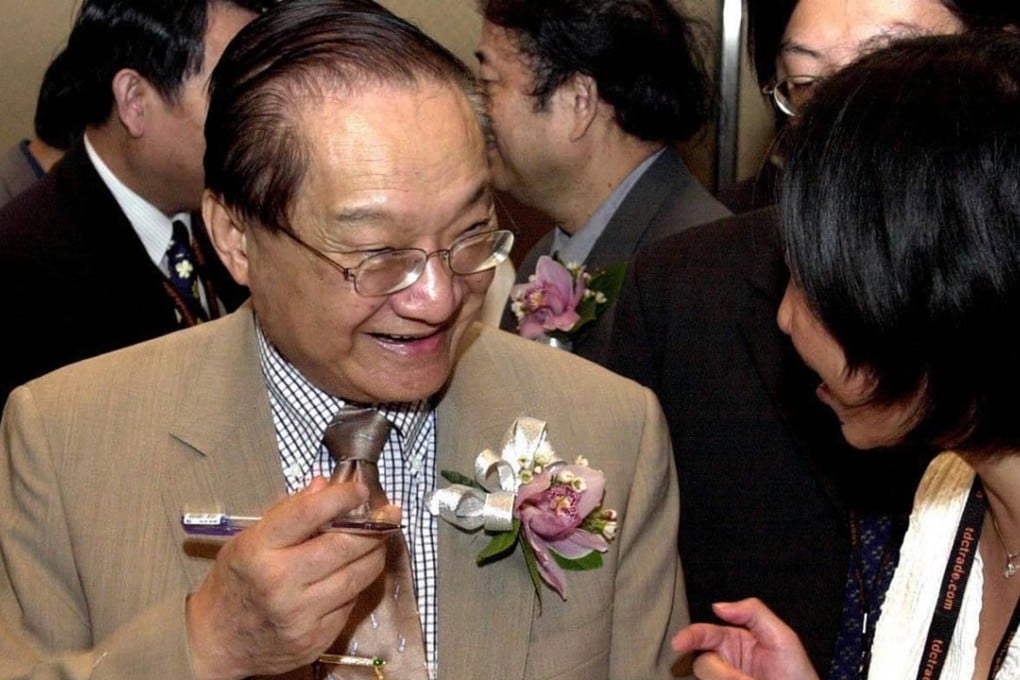 Louis Cha signs a book for a reader at the Hong Kong Book Fair. Photo: AP