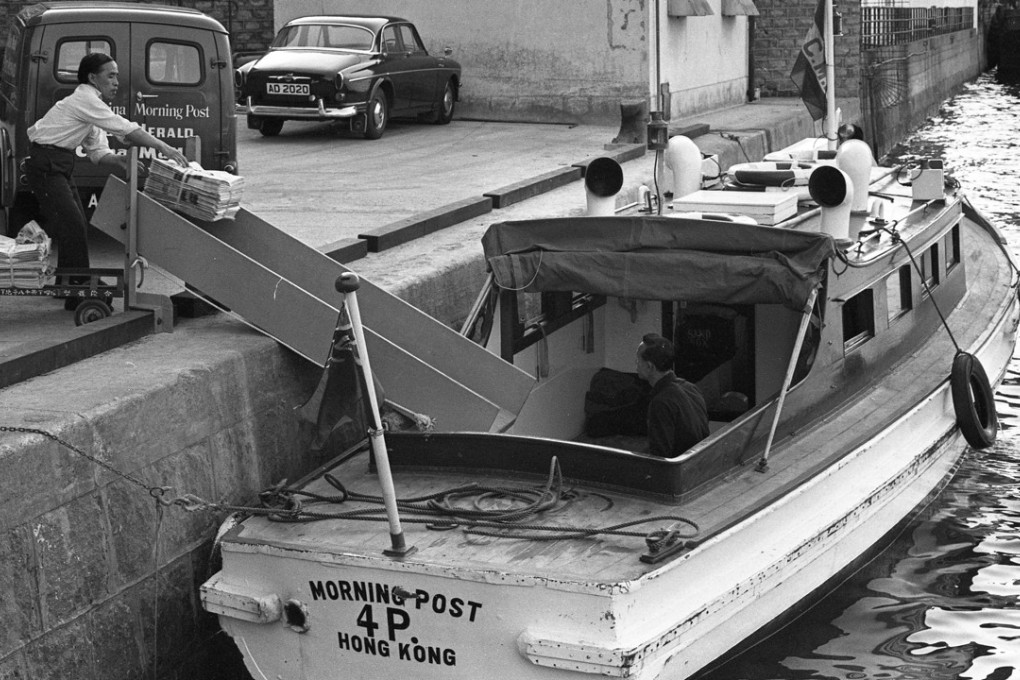 A worker loading a stack of newspapers into the Morning Post boat for delivery outside the South China Morning Post building at Tong Chong Street, Quarry Bay, in 1971.