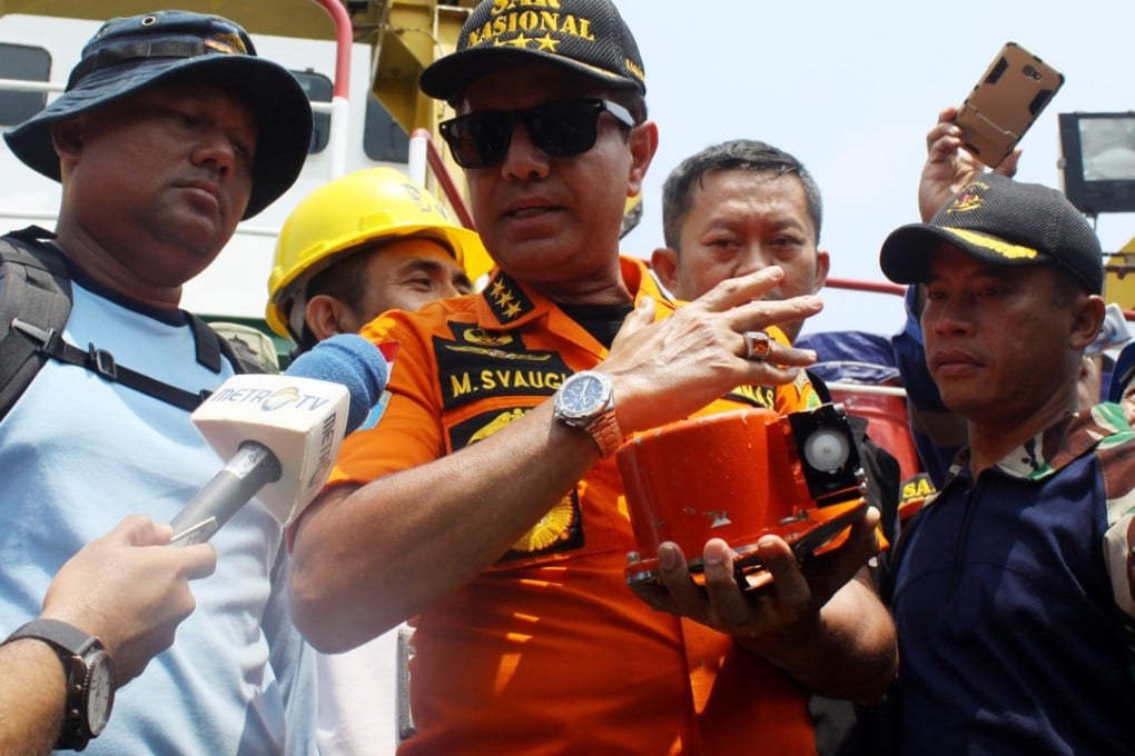 Chief of Indonesia’s National Search and Rescue Agency Muhammad Syaugi displays the core of the Lion Air JT610 flight data recorder, or black box, to journalists shortly after it was found on Thursday. The box’s external casing and electronics were shattered when the plane crashed. Photo: EPA