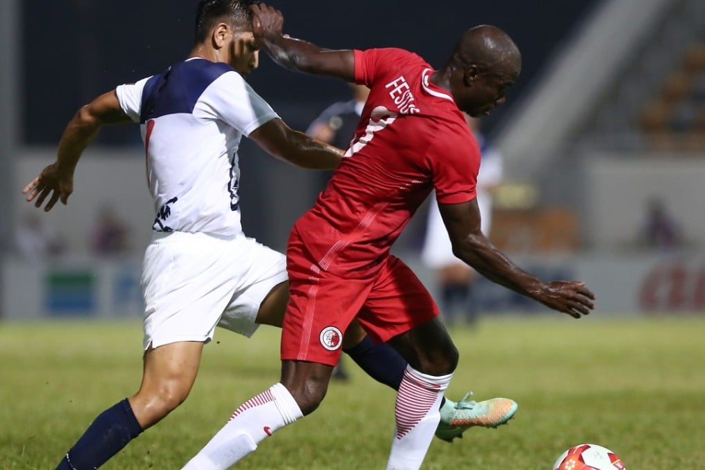 Hong Kong veteran Festus Baise (right) in action against Guam at Mong Kok Stadium. Photo: Jonathan Wong