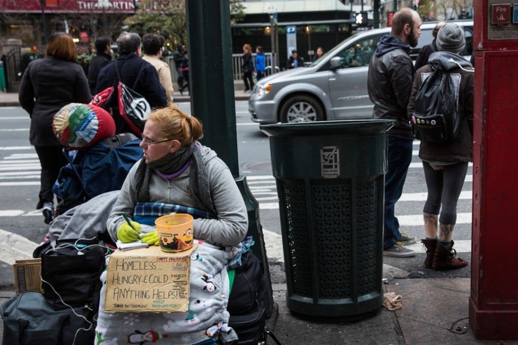 A woman begs for change near in New York, where the homeless population has ballooned. The US has the highest level of economic inequality among developed countries, according to Joseph Stiglitz. Photo: Getty Images/AFP