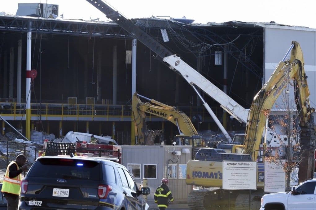Emergency personnel look over damage on Saturday after a weather-related building collapse at an Amazon distribution warehouse on Baltimore's southeast side Friday night. The Baltimore Sun via AP