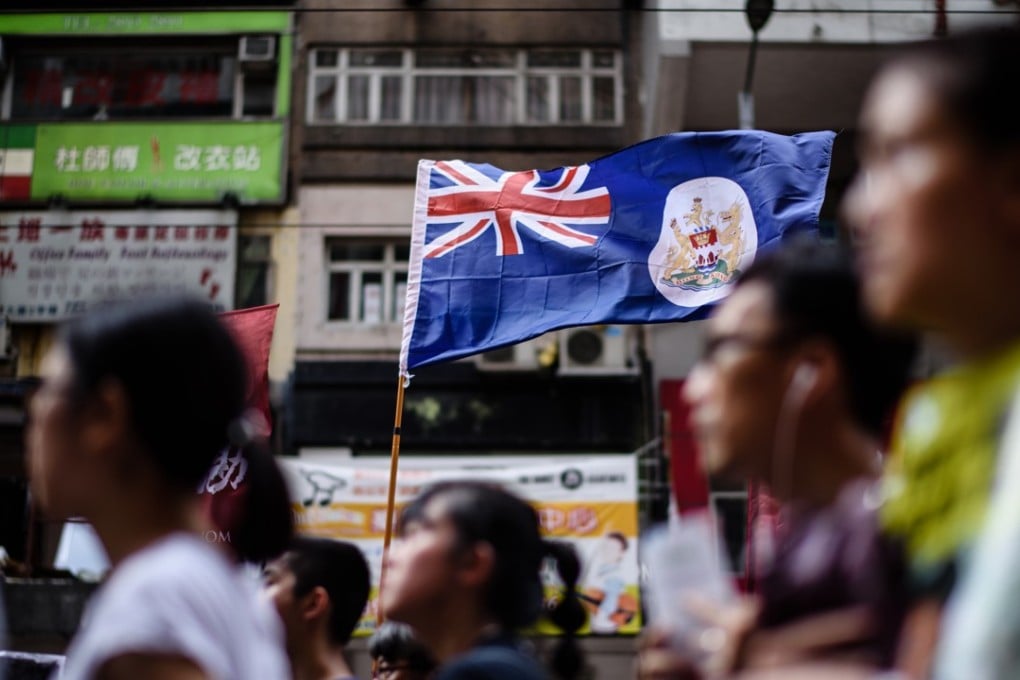 Hong Kong's colonial flag is held up during a protest march in Hong Kong on July 1, 2017, on the 20th anniversary of the city's handover from British to Chinese rule. Photo: AFP