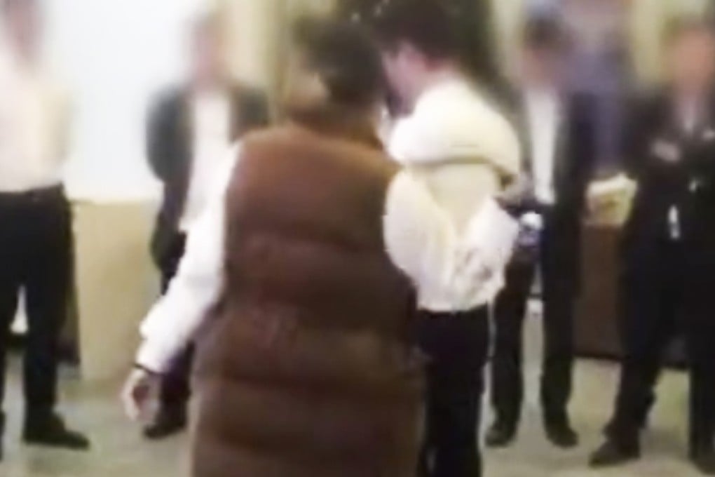 The video posted on social media shows a man being whipped with a belt and people drinking cups of yellow liquid. Photo: Miaopai.com