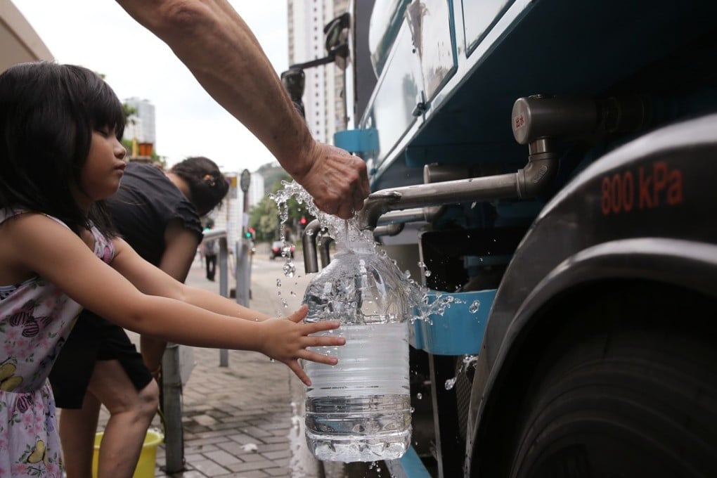 Residents fill up containers of drinking water from a temporary standpipe, after a partial power failure at Hiu Kwong Street in Sau Mau Ping in June 2016. Photo: Sam Tsang