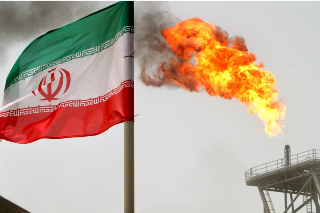 A gas flare on an oil production platform by an Iranian flag in the Persian Gulf. Photo: Reuters