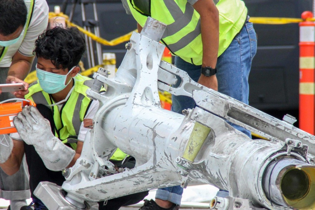 Lion Air investigators examine part of the landing gear of ill-fated Lion Air flight JT 610 in Jakarta on Monday. Photo: AFP