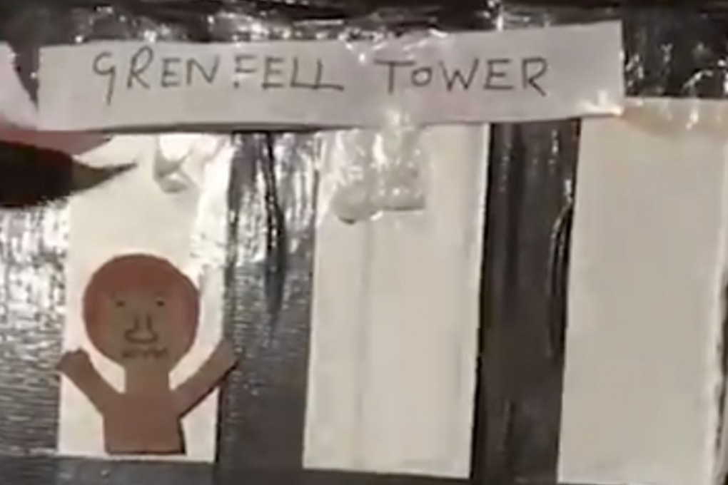 The footage showed a group of adults placing a cardboard effigy of the tower on a bonfire. The cardboard cut-out has Grenfell Tower written across the top and drawings of victims standing at the windows of the building. Photo: Twitter