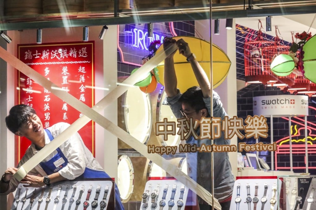 Staff at a shop in Central seal windows with masking tape, as Typhoon Mangkhut approached Hong Kong on September 15. Photo: Felix Wong