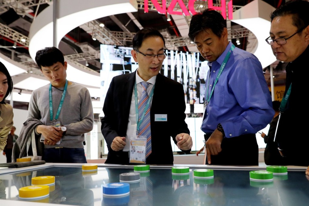 A Siemens representative shows an energy system to visitors at the first China International Import Expo in Shanghai on Monday. Photo: Xinhua