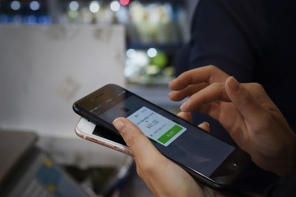 A woman makes a purchase on her smartphone in Beijing. Technology companies are among the industries that enjoy the highest level of trust in China. Photo: AFP