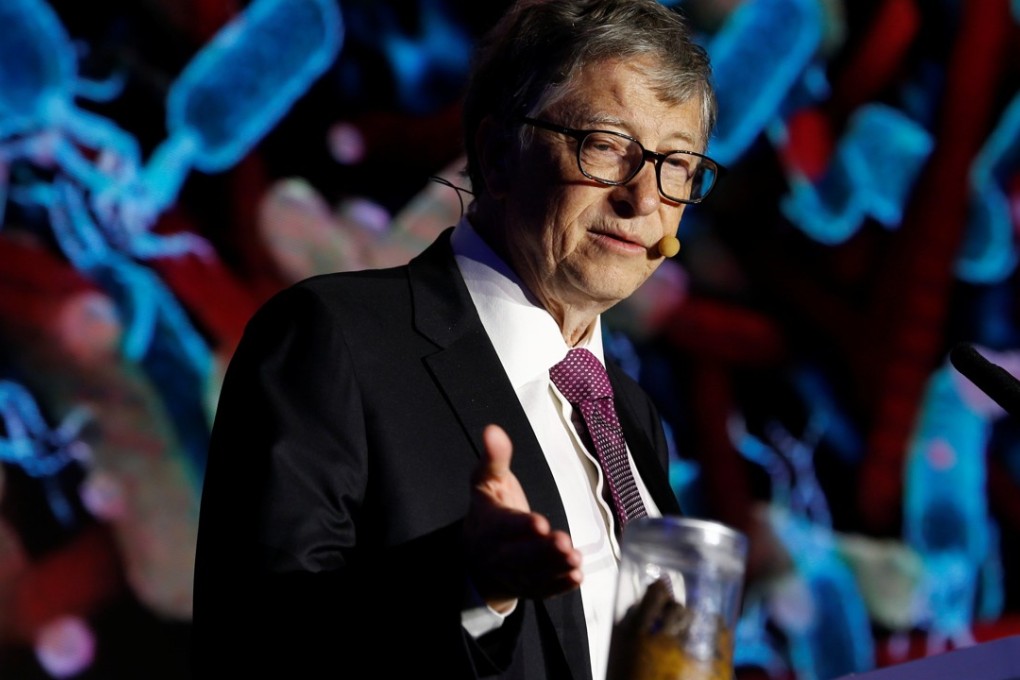 Bill Gates points at a jar containing human faeces during his speech at the Reinvented Toilet Expo in Beijing on Tuesday. Photo: Reuters