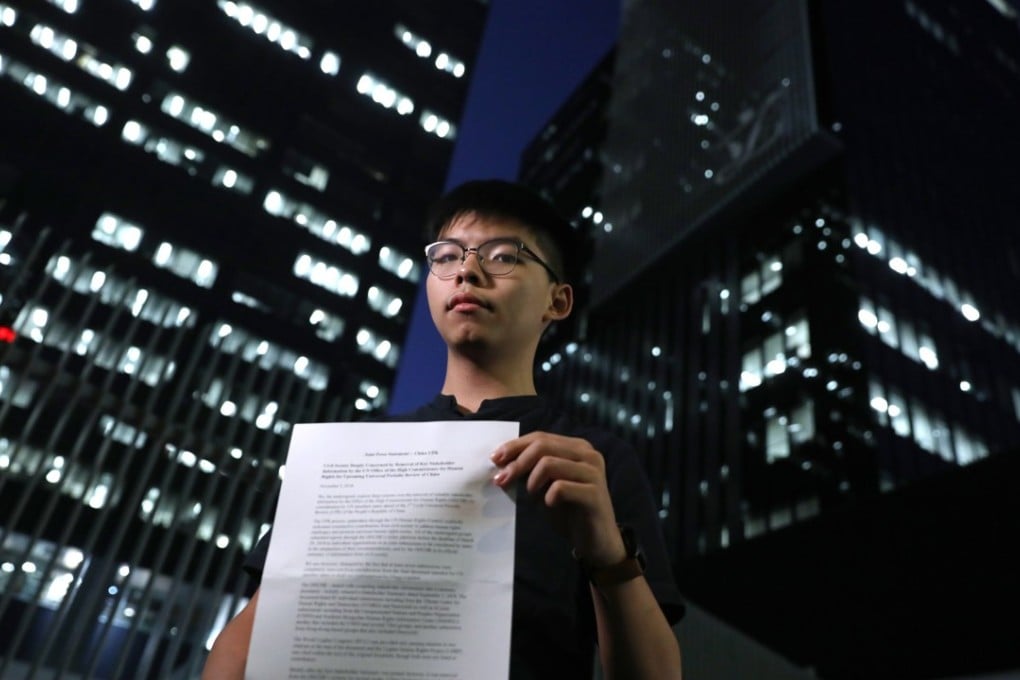 Activist Joshua Wong Chi-fung, secretary-general of pro-democracy party Demosisto, with the party’s report.Photo: Sam Tsang
