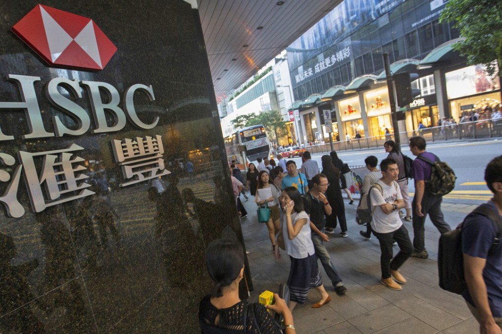 People walk past the HSBC logo in Central District on October 29. HSBC posted strong third-quarter profits, despite a leaked memo, revealed in September, from investment bankers that criticised the company’s “utterly failed” investment banking strategy. Photo: EPA-EFE
