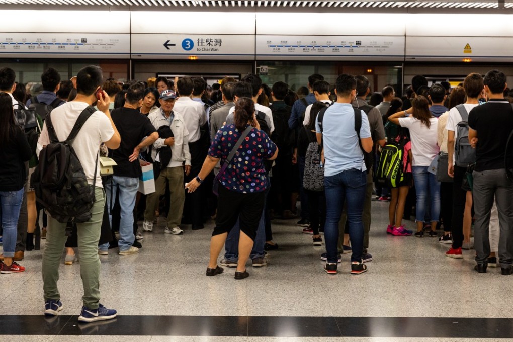 Commuters wait at Central MTR Station in Hong Kong on October 16, the day several major MTR lines suffered delays due to a simultaneous signalling glitch. Photo: Bloomberg
