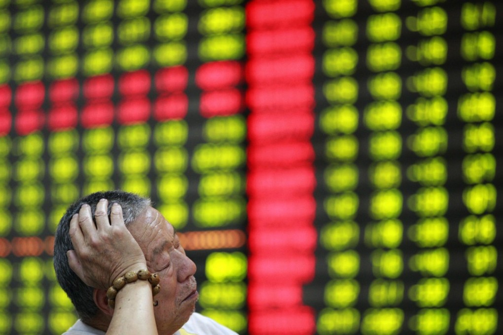 An investor napping in front of an electronic board at a brokerage house in Huaibei, Anhui province on June 4, 2012. Contrary to global conventions, China’s stock market uses the colour red to represent gains and advances, using green to denote losses and declines, so a greenlit board represents losses across the market. Photo: REUTERS