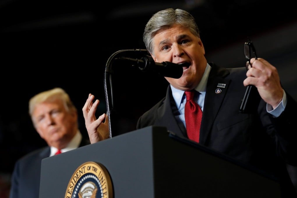 US President Donald Trump listens as Sean Hannity from Fox News speaks at a campaign rally in Cape Girardeau, Missouri on Monday. Photo: Reuters