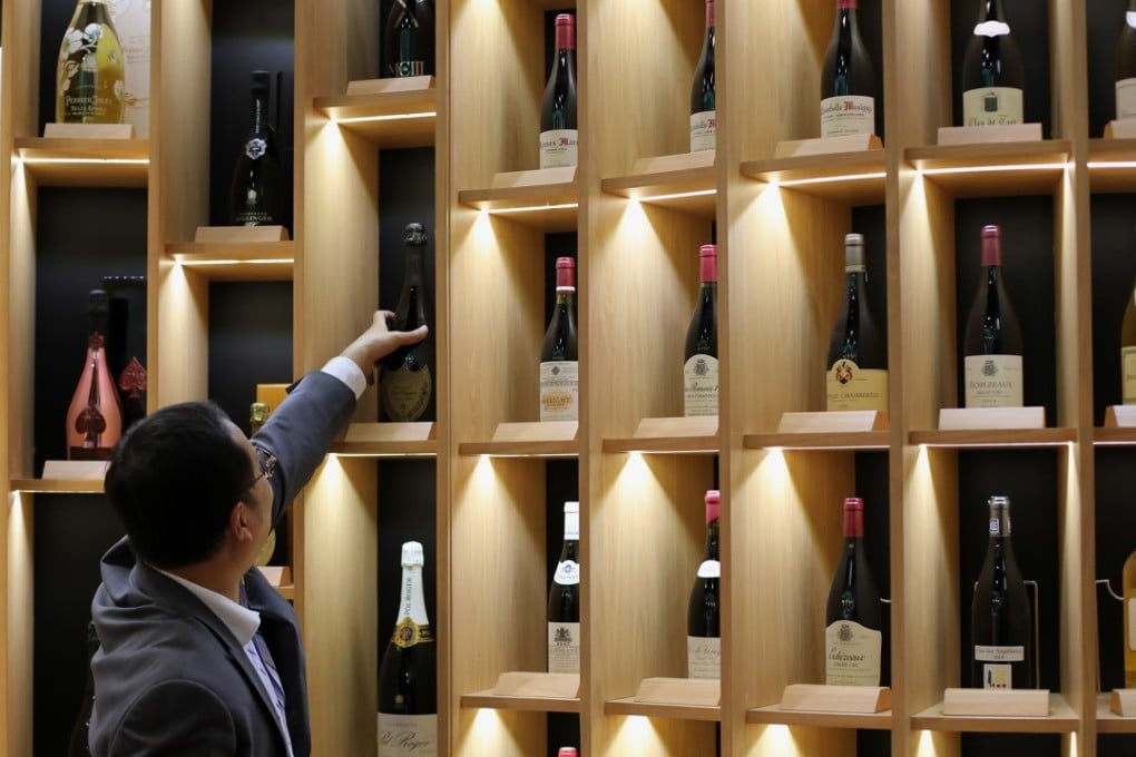 A man selects a bottle at the Hong Kong Trade International Wine and Spirits Fair, at the Hong Kong Convention and Exhibition Centre in Wan Chai. Photo: K.Y. Cheng