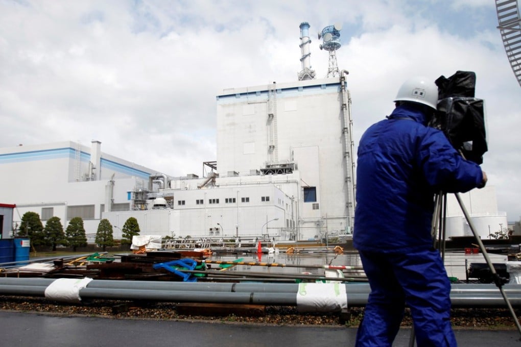 A cameraman films the Tokai Daini nuclear power plant's reactor during a media tour. Photo: Reuters