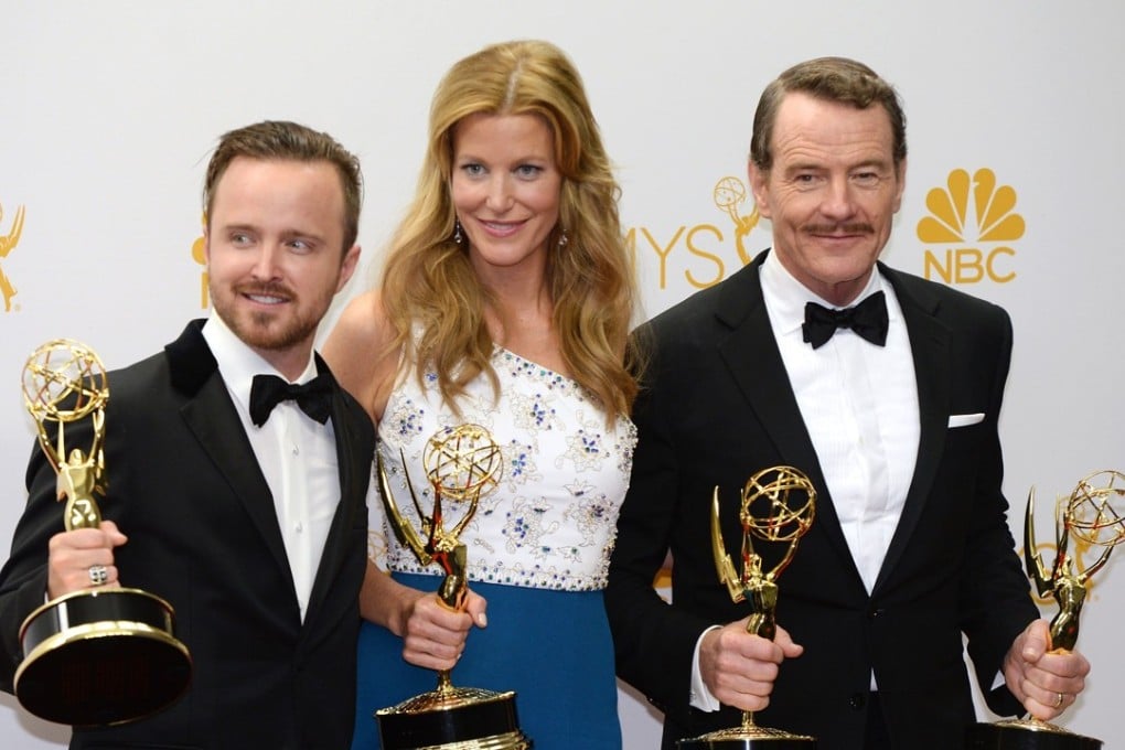 Aaron Paul (left), Anna Gunn and Bryan Cranston pose with the Emmys Breaking Bad won in 2014 for outstanding drama series, lead actor, supporting actor and supporting actress. Breaking Bad is coming back in movie format, Cranston says. Photo: AFP
