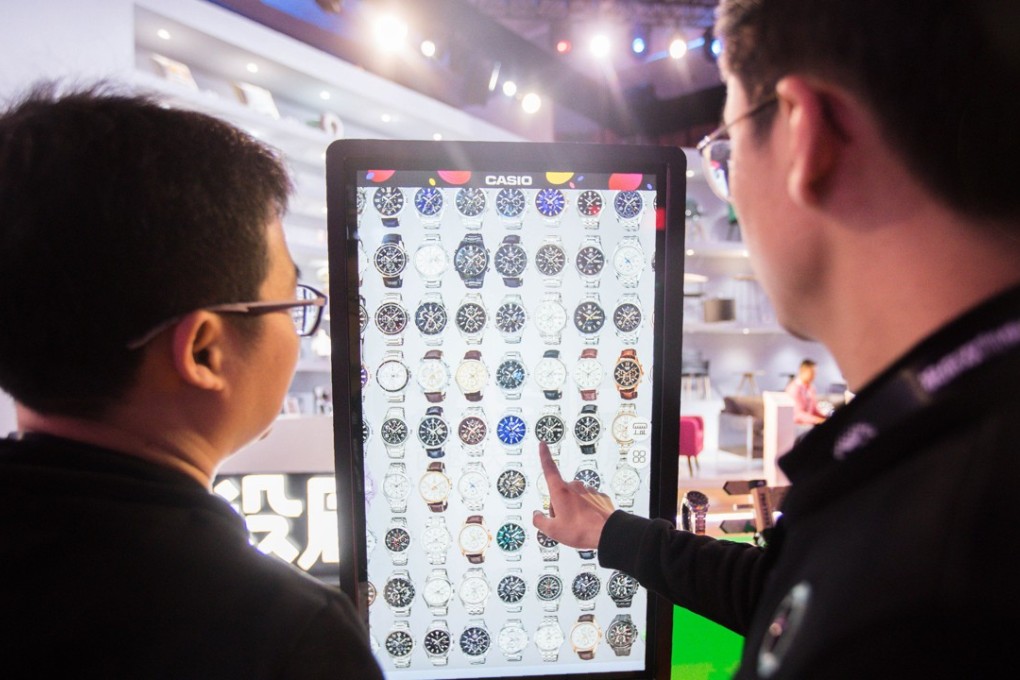 People select watches on an electronic screen at a T-Mall exhibition during the Singles’ Day shopping festival in 2017. Knowing what you want beforehand will save you time, and money. Photo: AFP