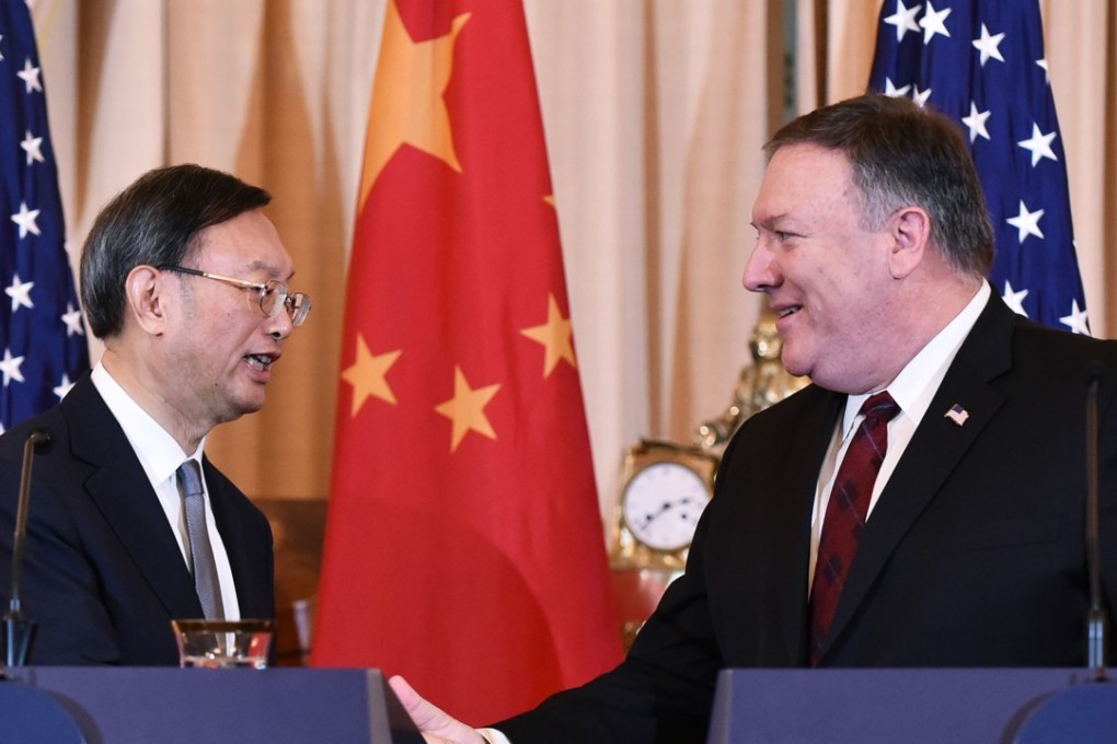 Yang Jiechi and Mike Pompeo shake hands following their press conference in Washington. Photo: AFP