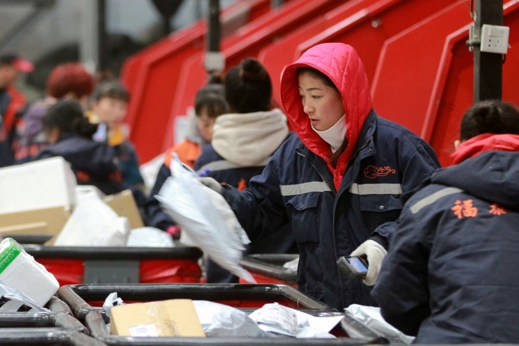 Employees scan boxes and parcels at the logistics centre of an express delivery company in Harbin, China, on November 13, 2017 after the Singles’ Day online shopping festival. Foreign firms are eager for access to China’s vast consumer market. Photo: Reuters