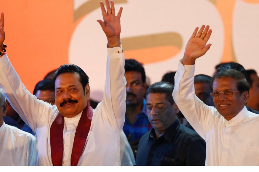 Sri Lanka's newly appointed Prime Minister Mahinda Rajapaksa (left) and President Maithripala Sirisena wave to supporters during a rally near the parliament in Colombo on Monday. Photo: Reuters