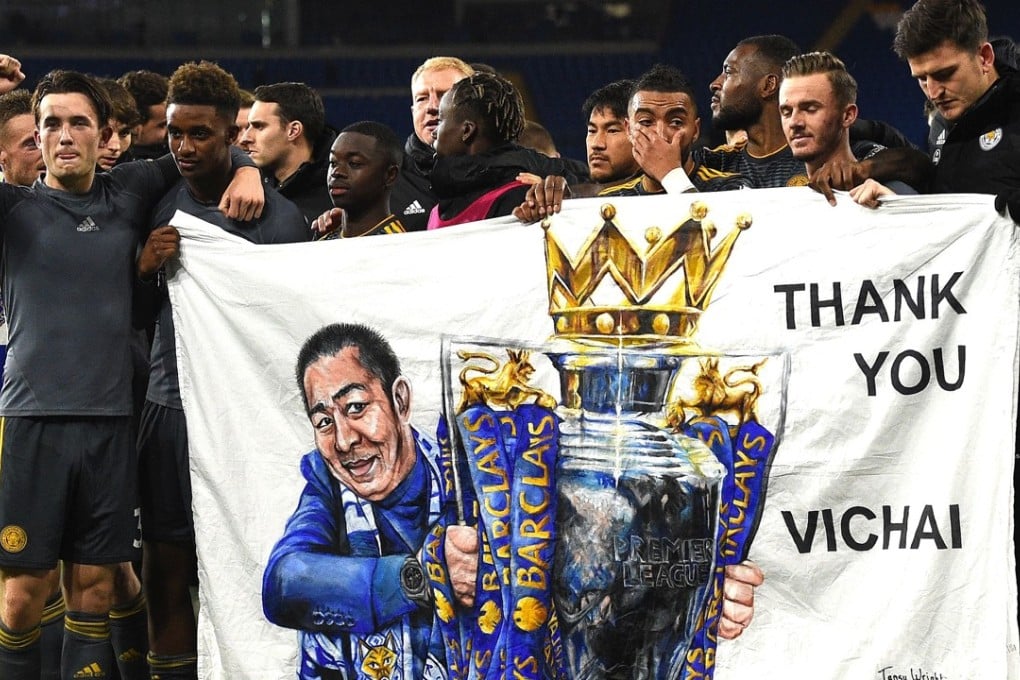 Leicester’s players hold a banner in tribute to Vichai Srivaddhanaprabha. Photo: AFP