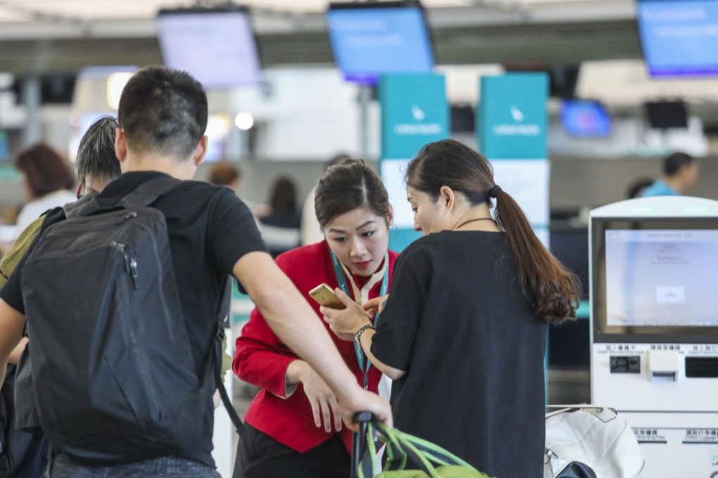 Cathay Pacific staff help out passengers at the airline’s check-in counters at Hong Kong International Airport on October 29. The company announced on October 24 that the personal data of 9.4 million customers had been compromised. Photo: Felix Wong