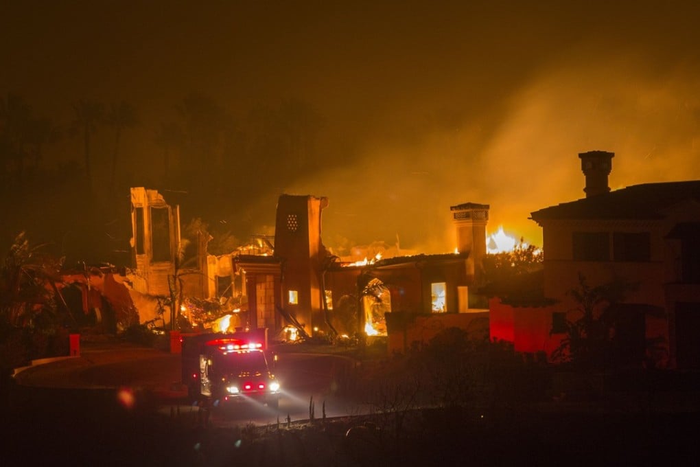 Buildings burn during the Woolsey Fire in Malibu, California. After a experiencing a mass shooting, residents of Thousand Oaks are threatened by the ignition of two nearby dangerous wildfires. Photo: AFP
