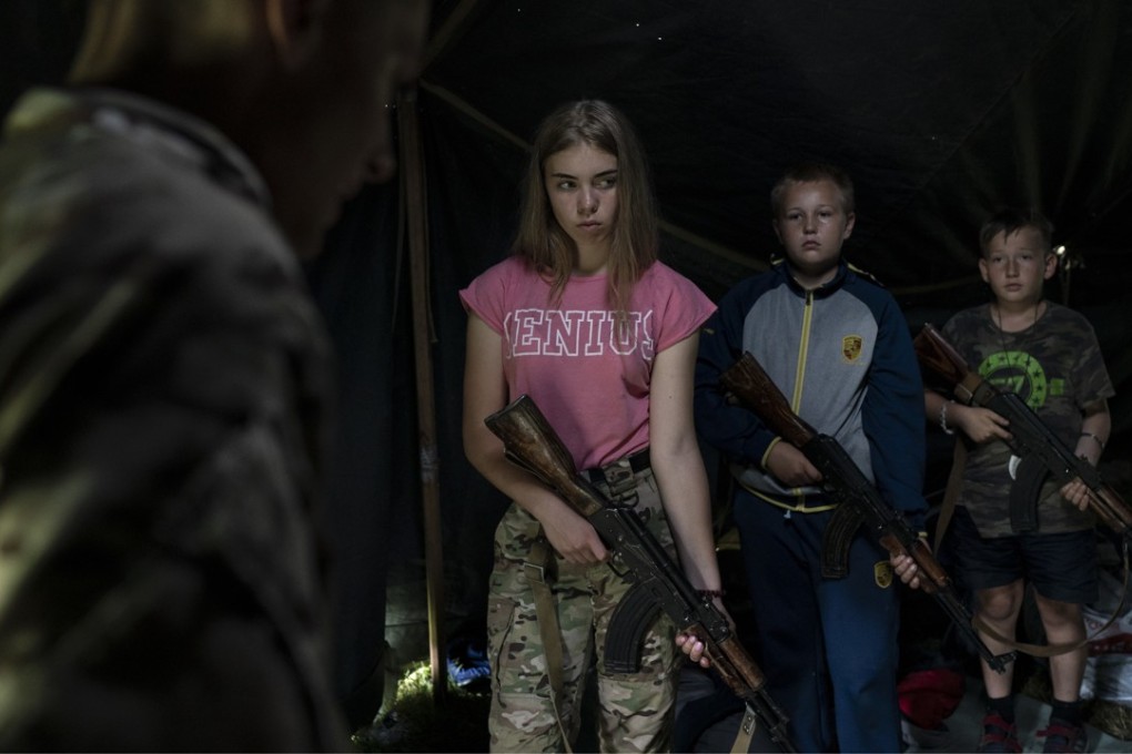 A July 2018 photo of children armed with AK-47s at the ‘Temper of Will’ summer camp near Ternopil, Ukraine, which is organised by the nationalist Svoboda party. Photo: AP