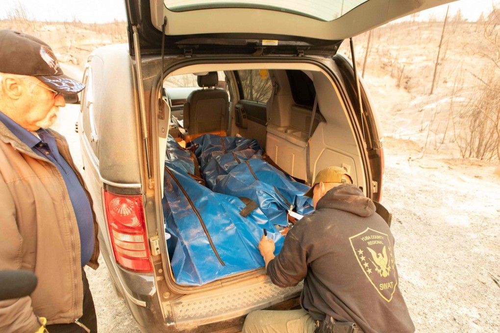 Yuba and Butte County Sheriff officers label a body bag in Concow, California. Photo: AFP