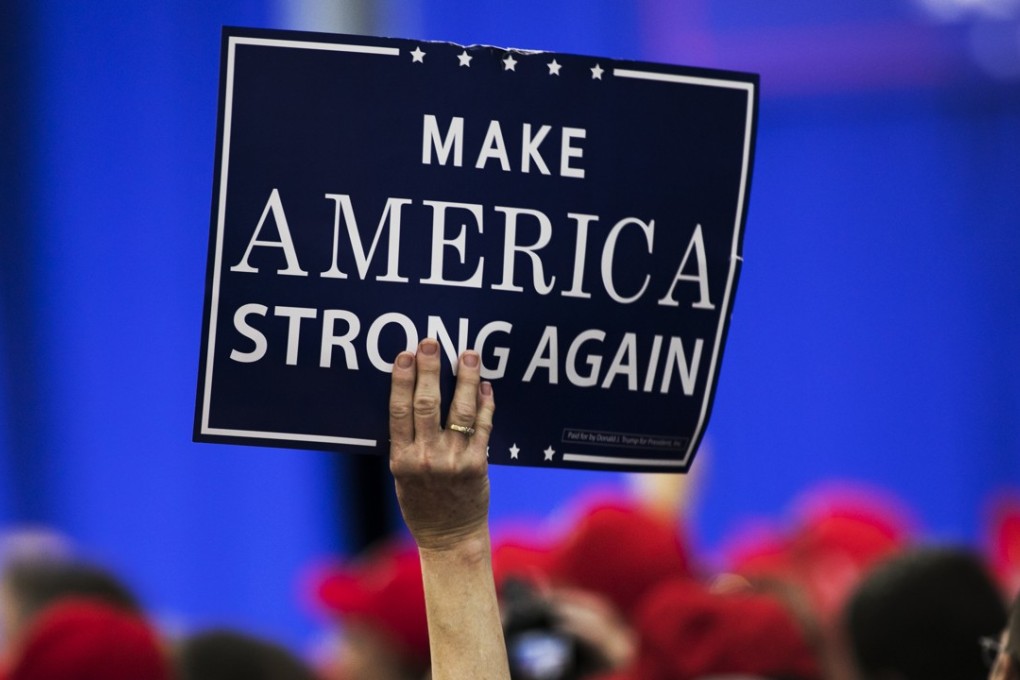 An attendee holds a placard during a rally with US President Donald Trump in Ohio, on August 4, 2018, when Trump defended his use of tariffs that have inflamed tensions with China and Europe, telling an audience of supporters that playing hardball on trade is "my thing". Photo: Bloomberg